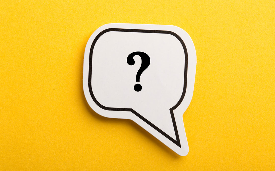 Cut out of a white speech bubble with a black outline. Inside the speech bubble is a question mark. The background of the image is yellow. 