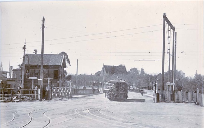 Image of Tram crossing Merri Creek into Northcote. All Saints Church is in the background. [LHRN202]