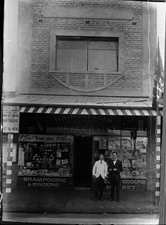 Image of Norman Outram outside his hairdressers shop c.1925