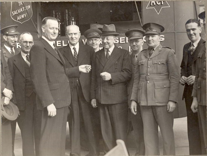 Image of Robinson presenting a mobile canteen to the Salvation Army