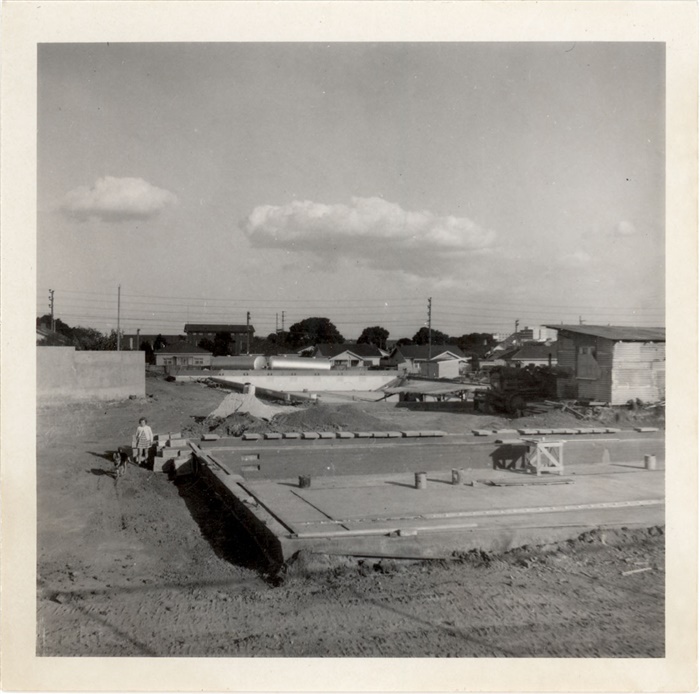 Image of Construction of Preston Olympic Pool 1964. Debbie, daughter of Peter Cairns, the Pool Manager, is in the foreground with dog