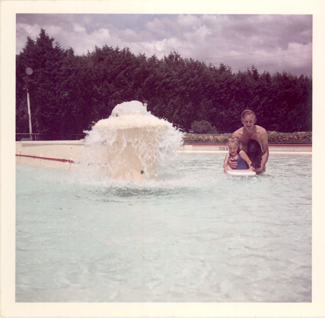 Photograph taken of Preston Olympic Pool in the late 1960s. The Pool Manager, Peter Cairns, his daughter, Debbie and dog appear in the photograph. The fountain marked the spot where the shallow water started. [LHRN2293]