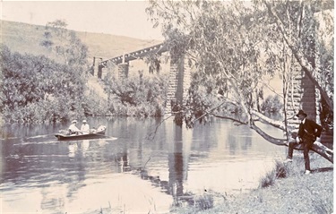 Image of Boat passes beneath Pipe Bridge near Rudder Grange