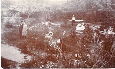 Image of Cooke family at Rudder Grange boathouse