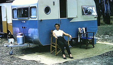 Winifred Latham outside the family’s 14 foot bondwood Viking caravan at Rosebud, Victoria 1959 [LHRN5437-31]