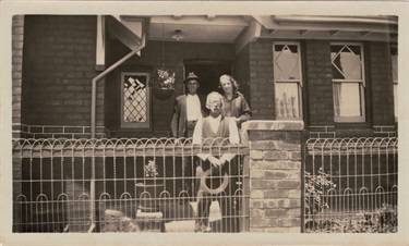 Thomas, Lima and Leo Breese in front of their house on the corner of Edwardes St and Byfield Street Reservoir. The two storey brick bungalow is attached to a boot/shoe shop that was on Edwardes St.