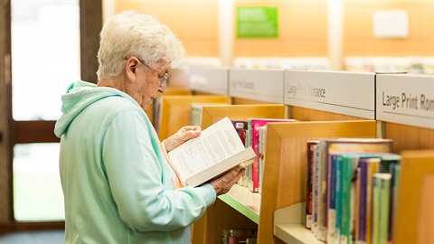An elderly person reading a book