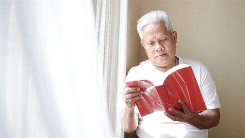 older person reading book